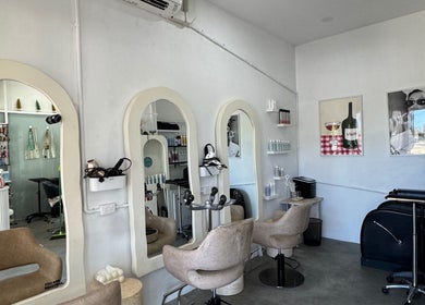 Modern interior of Isla Hair salon in Maroochydore, Queensland, AU with styling stations and chic decor.