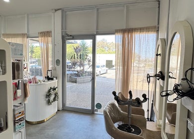 Interior of Isla hair in Maroochydore, Queensland, AU showcasing modern styling chairs and products.