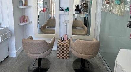 Modern salon chairs and mirrors at Isla Hair, Maroochydore, Queensland, AU, showcasing stylish decor.
