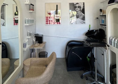 Modern salon interior at Isla Hair in Maroochydore, Queensland, AU featuring a plush chair and stylish decor.