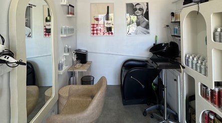 Modern salon interior at Isla Hair in Maroochydore, Queensland, AU featuring a plush chair and stylish decor.