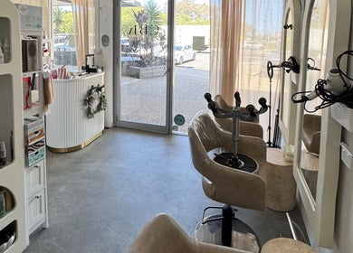 Modern Isla Hair salon interior in Maroochydore, Queensland, AU, with styling chairs and product display.