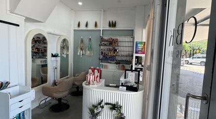 Interior of Isla Hair in Maroochydore, Queensland, AU showcasing stylish salon chairs and a welcoming reception.