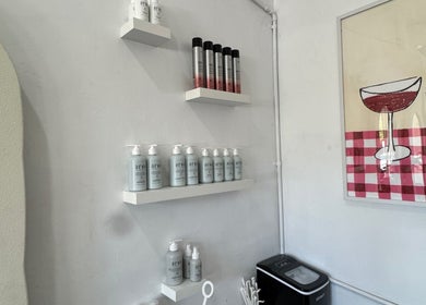 Modern hair product display at Isla Hair, Maroochydore, Queensland, AU, featuring stylish wall decor.