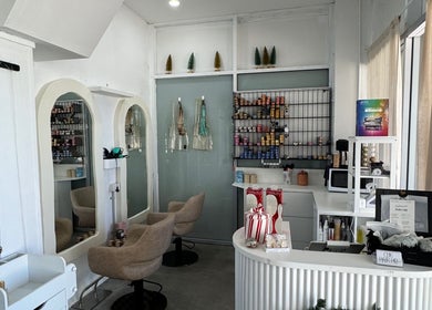 Interior of Isla Hair in Maroochydore, Queensland, AU, showcasing stylish salon chairs and product display.