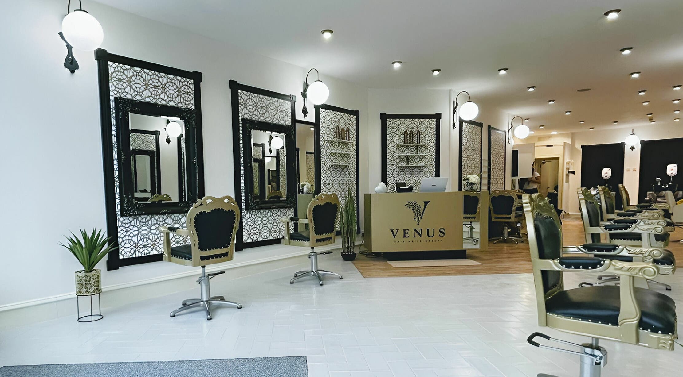 Elegant interior of Venus Salon in Kilmarnock, Scotland, GB, featuring stylish chairs and ornate mirrors.