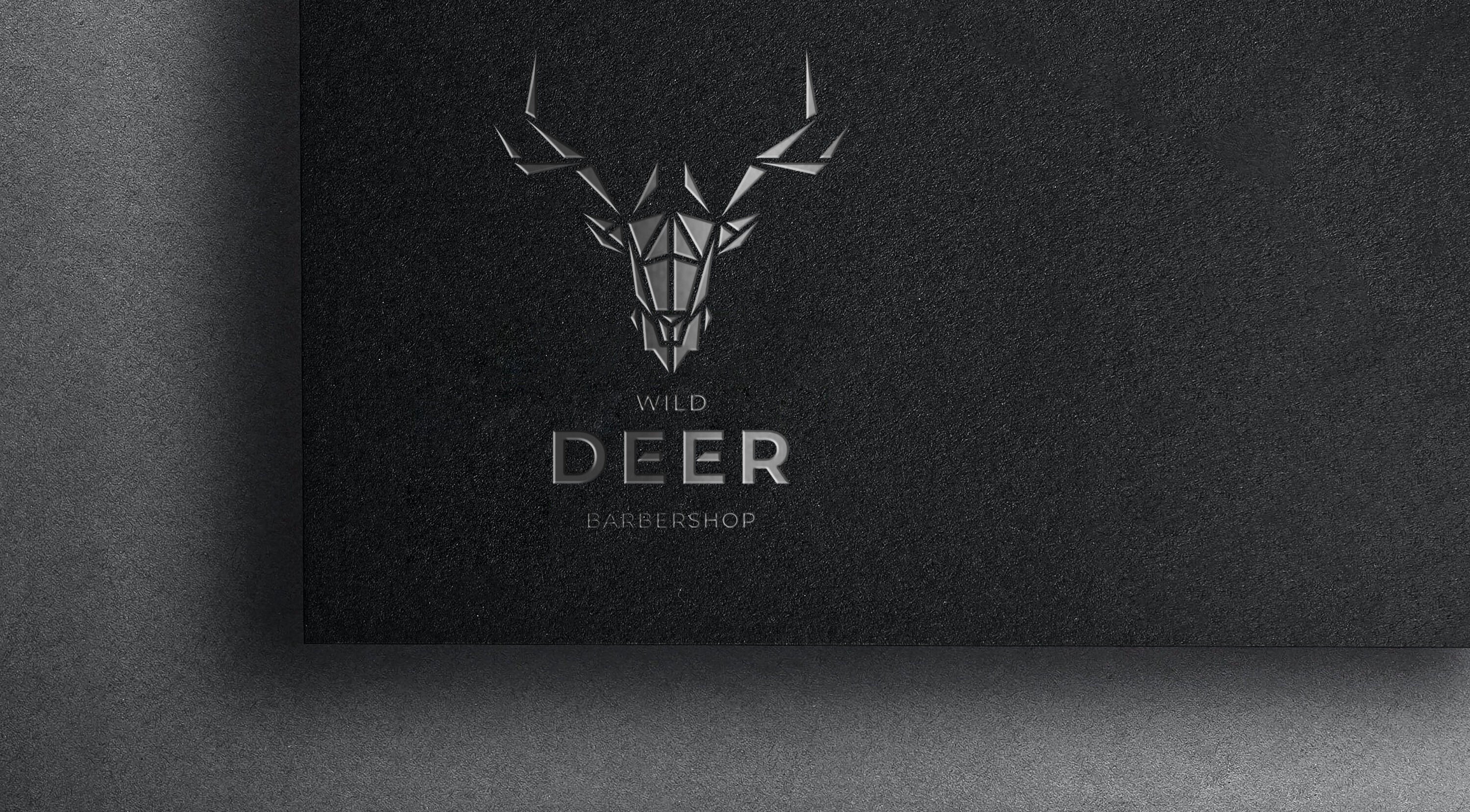Elegant deer logo of Wild Deer Barbershop, Amman, Amman Governorate, JO, engraved on a dark surface.