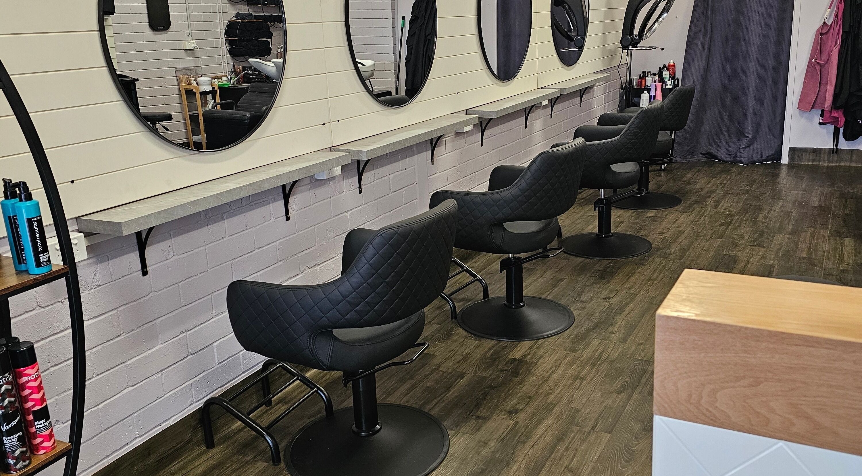 Elegant styling chairs at A.K.A Hair, Metford, New South Wales, AU, showcasing luxury and comfort.