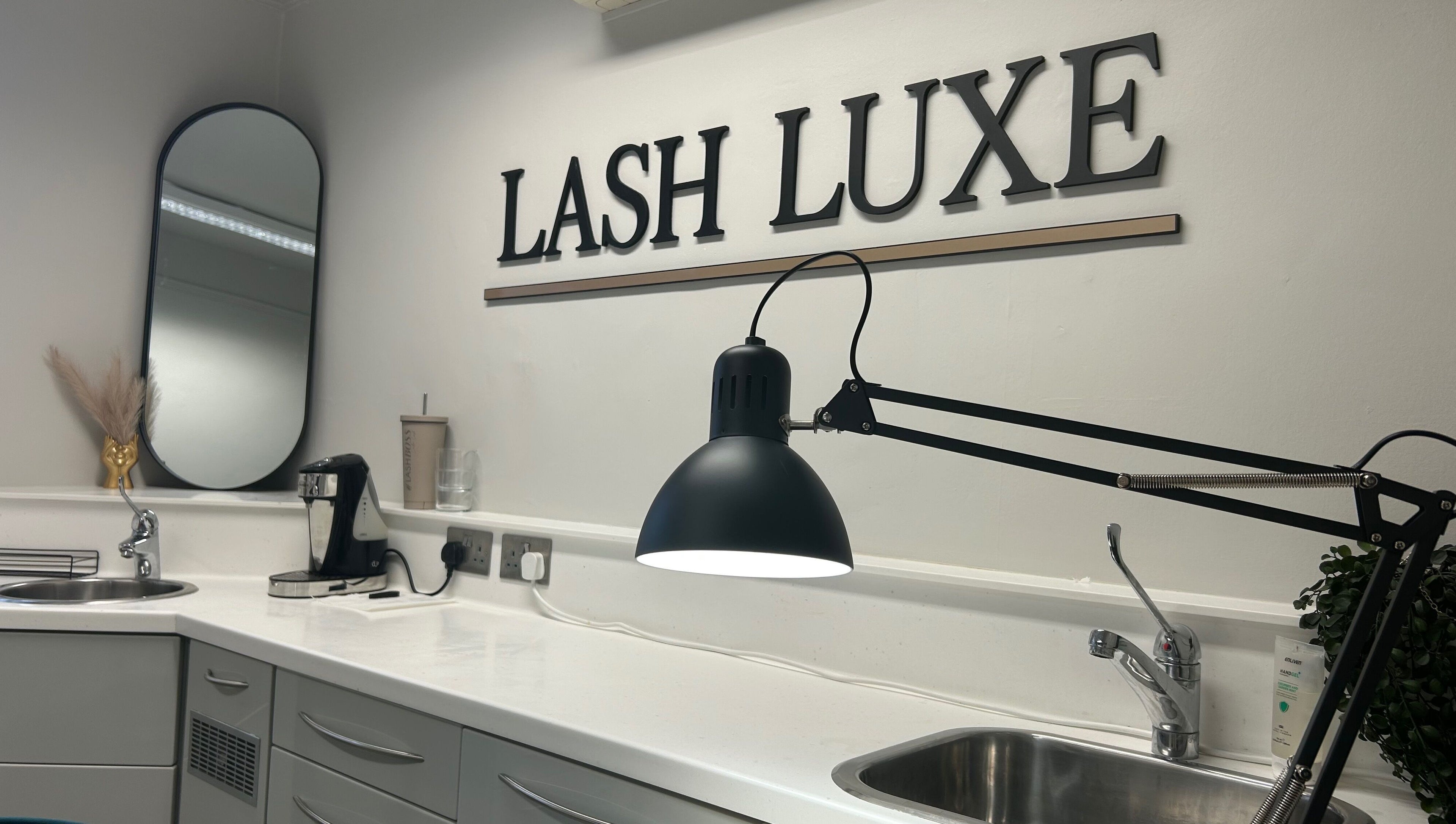 Modern workspace at Lash L'uxe & beauty, Peterborough, England, GB, featuring stylish decor and lighting.