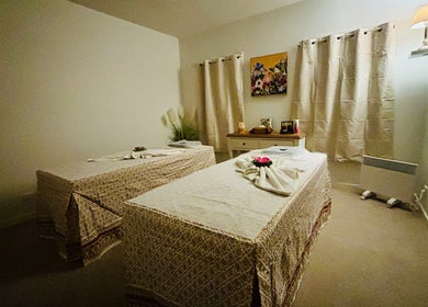 Cozy massage room at Charm Thai Therapy in Melbourne, Victoria, AU with two neatly arranged treatment tables.