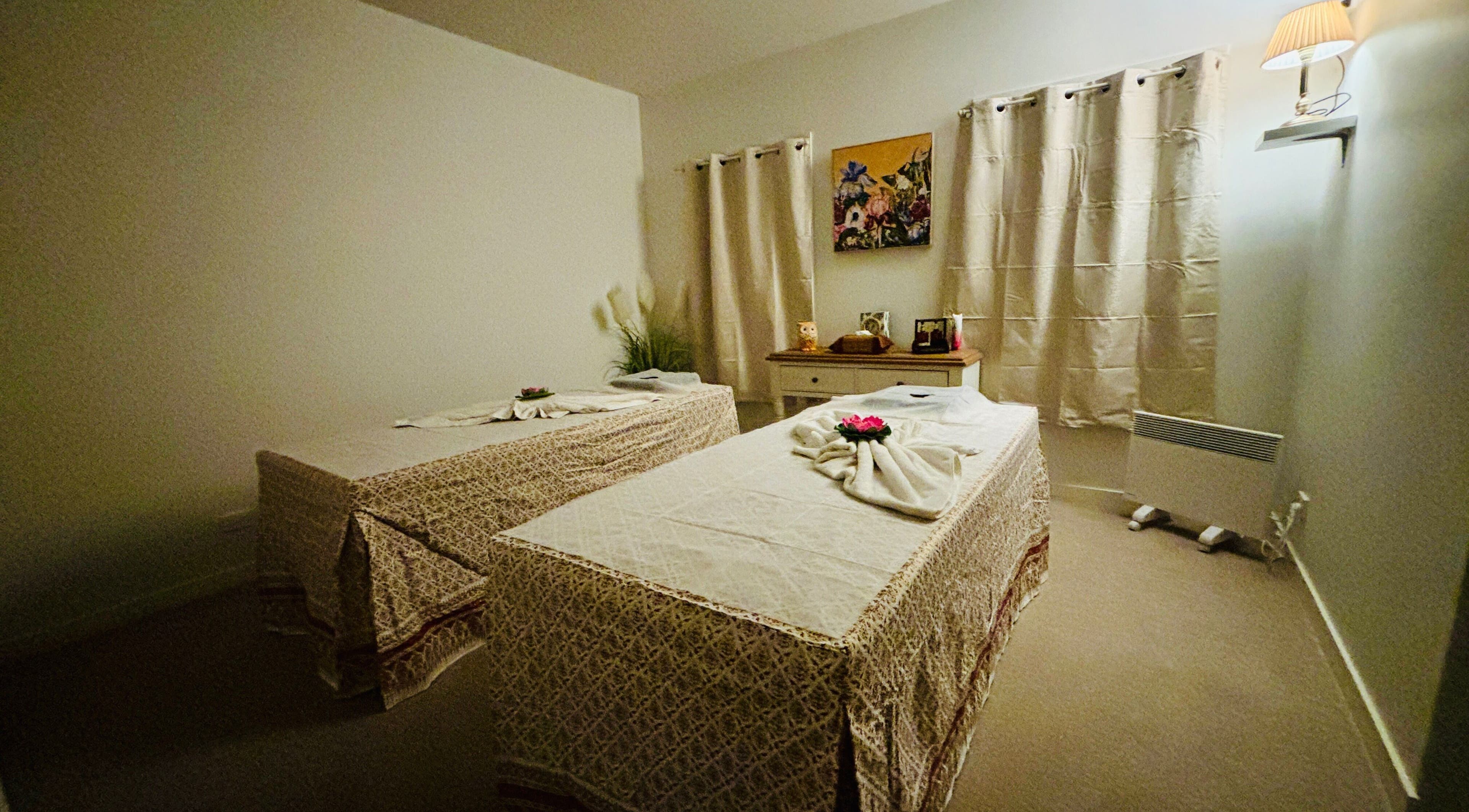 Cozy massage room at Charm Thai Therapy in Melbourne, Victoria, AU with two neatly arranged treatment tables.