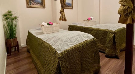 Relaxing spa room at Charm Thai Therapy, Melbourne, Victoria, AU with two massage beds in tranquil setting.