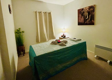 Serene massage room at Charm Thai Therapy, Melbourne, Victoria, AU with calming decor and ambient lighting.