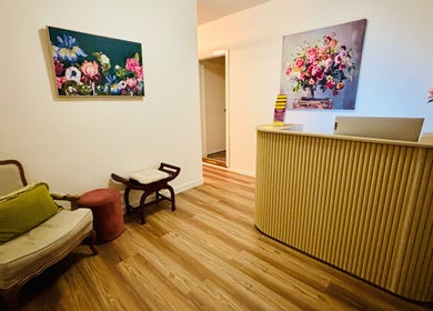 Cozy reception at Charm Thai Therapy, Melbourne, Victoria, AU with elegant decor and vibrant floral art.