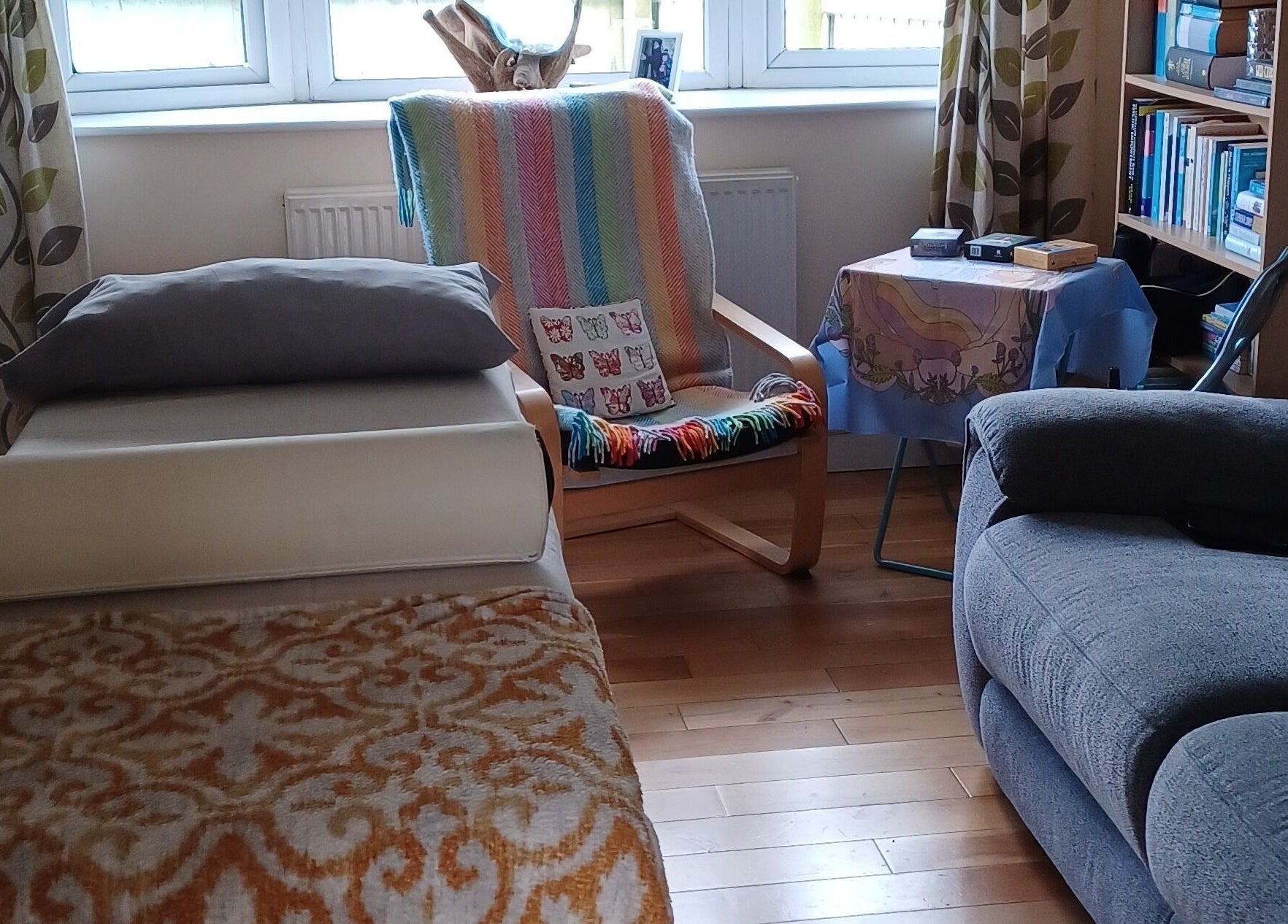 Cozy relaxation room at Kernow Serenity, Truro, England, GB, featuring a treatment bed and comfortable seating.