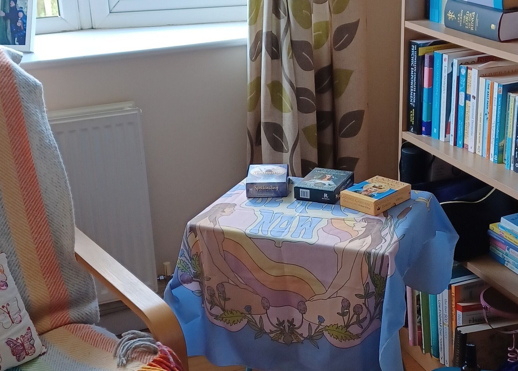 Cozy reading nook at Kernow Serenity, Truro, England, GB featuring books and a colorful throw.