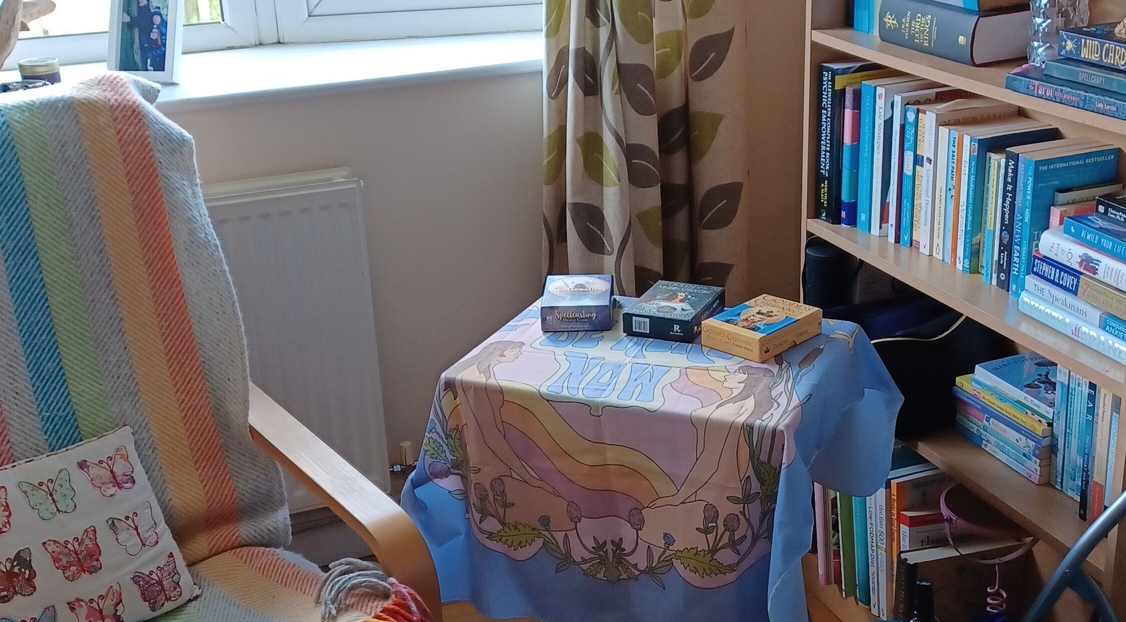 Cozy reading nook at Kernow Serenity, Truro, England, GB featuring books and a colorful throw.