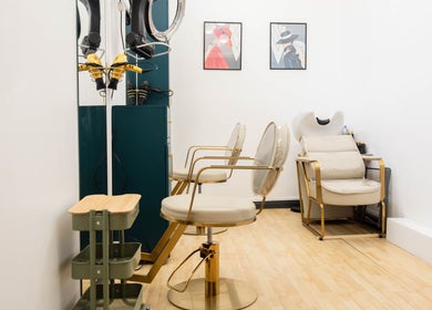 Elegant salon interior at Glaysson Carvalho Hair Studio in London, England, GB with stylish chairs and decor.