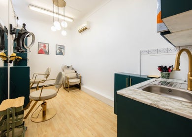 Chic interior of Glaysson Carvalho Hair Studio in London, England, GB, featuring stylish chairs and decor.