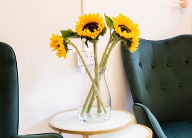 Chic waiting area with sunflowers at Glaysson Carvalho Hair Studio, London, England, GB.