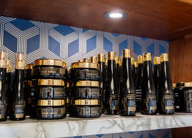 Premium hair care products at Glaysson Carvalho Hair Studio, London, England, GB displayed on a stylish shelf.