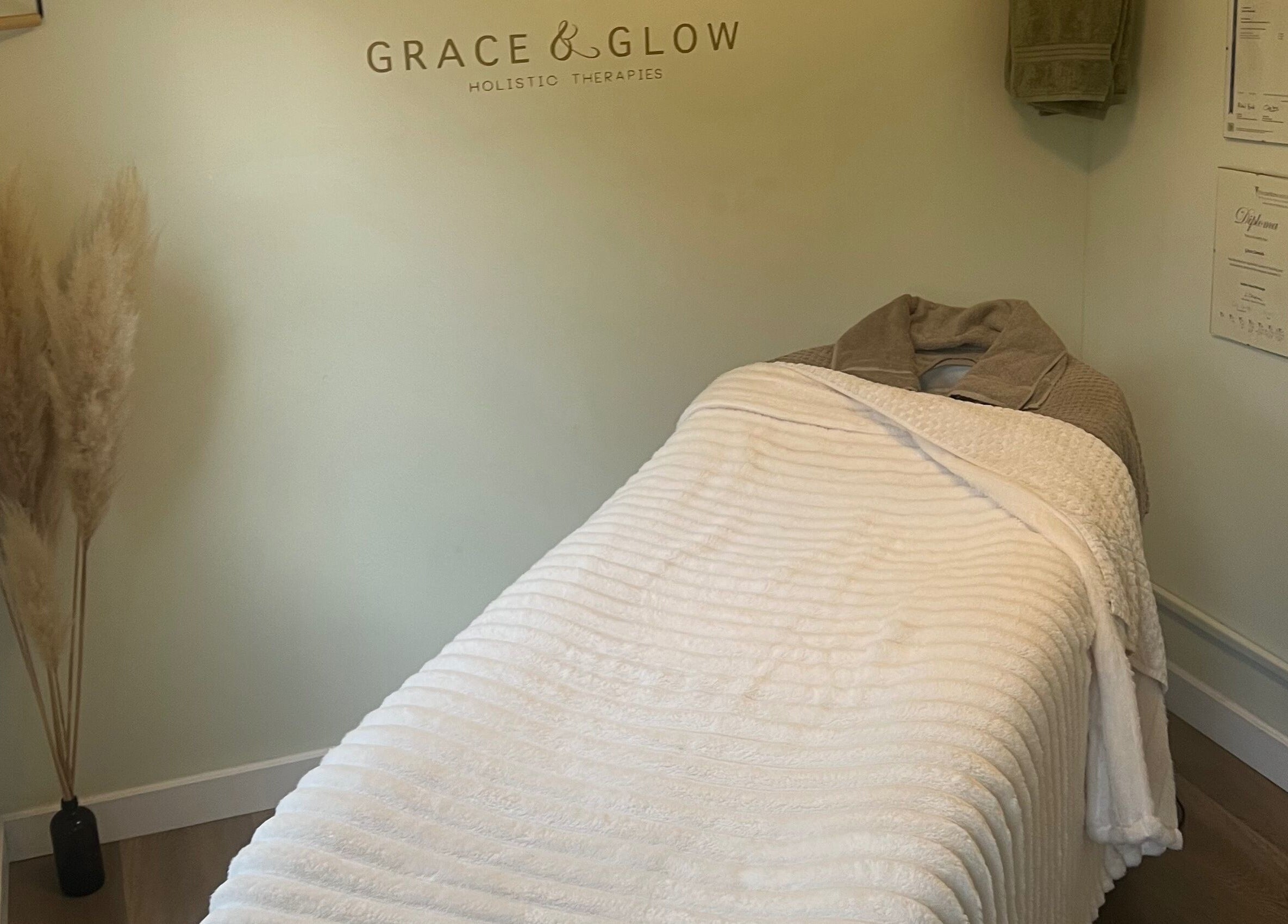 Cozy therapy room at Grace & Glow, Maidstone, England, GB, featuring a white massage table and soft decor.