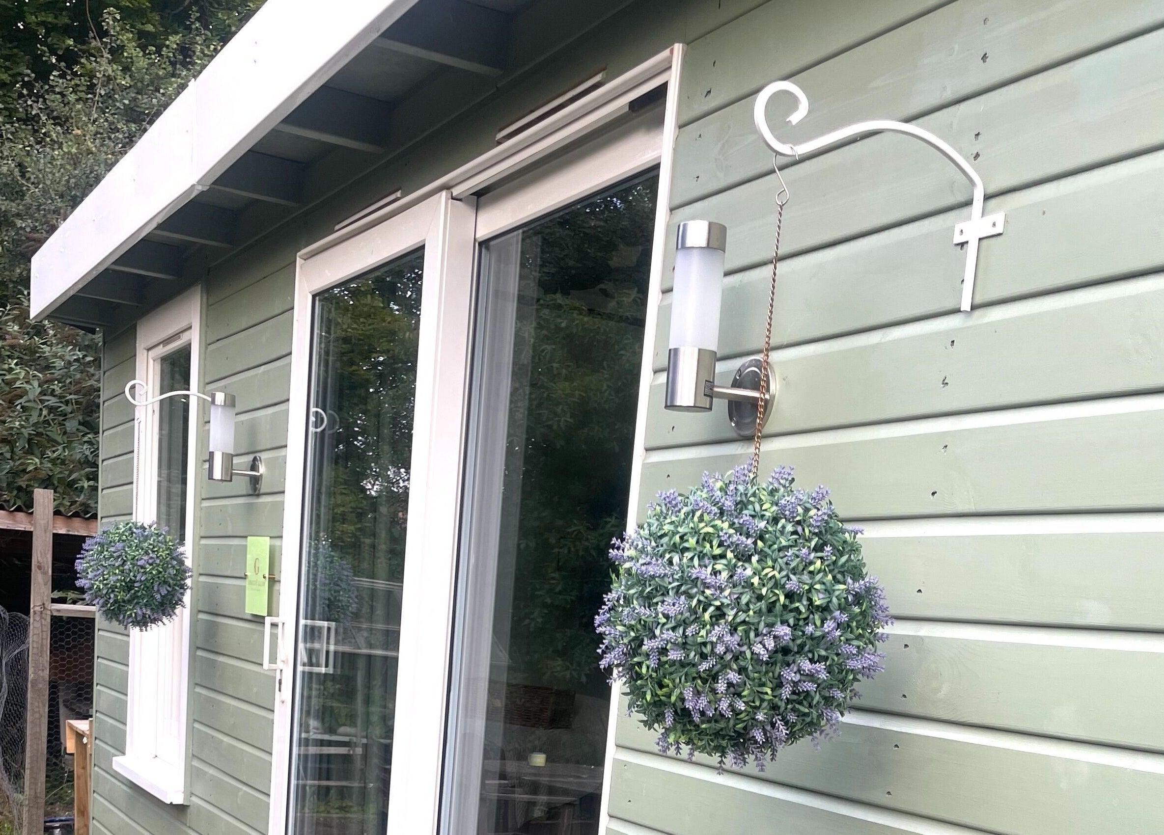 Grace & Glow's tranquil green facade in Maidstone, England, GB with hanging lavender planters.