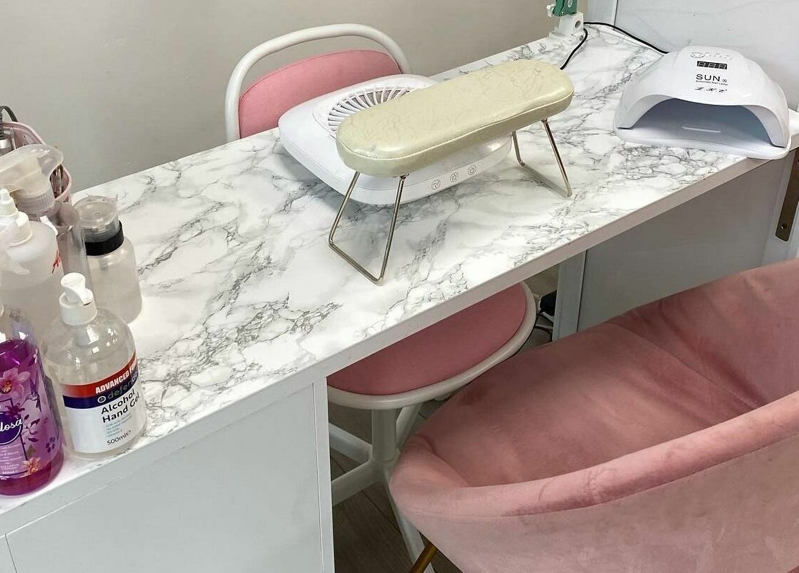 Elegant nail care setup at FN Gel Bar, Rowley Regis, England, GB with pink seating and marble counter.