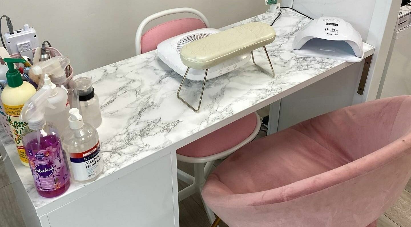 Elegant nail care setup at FN Gel Bar, Rowley Regis, England, GB with pink seating and marble counter.
