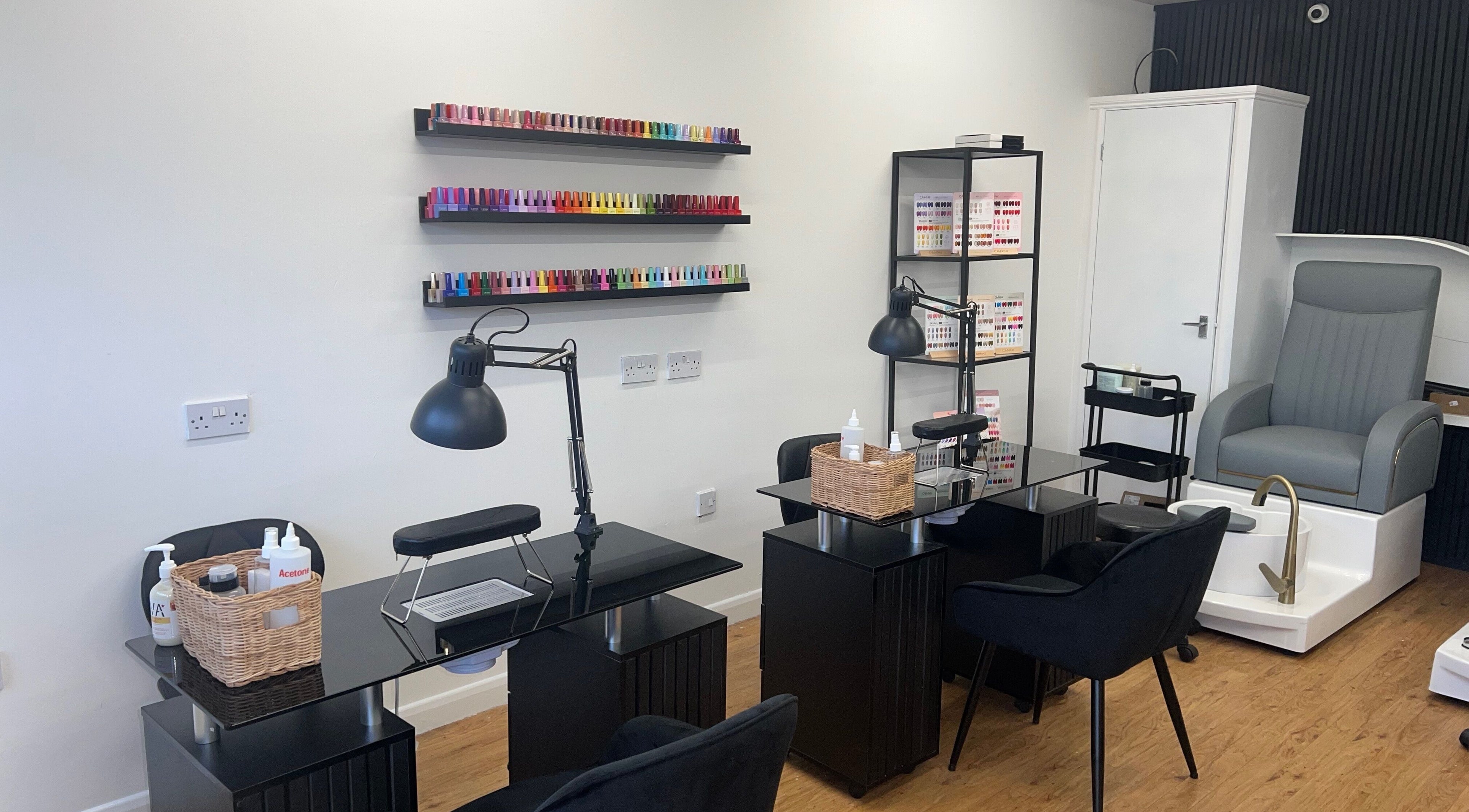 Nail salon interior at FN Gel Bar Wordsley, Stourbridge, England, GB, featuring nail polish displays and seating.