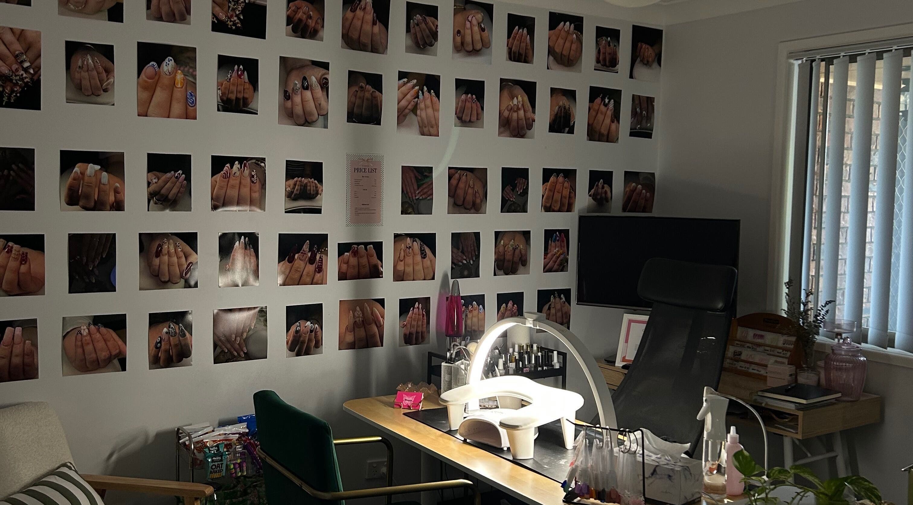 Glossie Nails workspace in Rochedale South, Queensland, AU, showcasing diverse nail art on wall gallery.