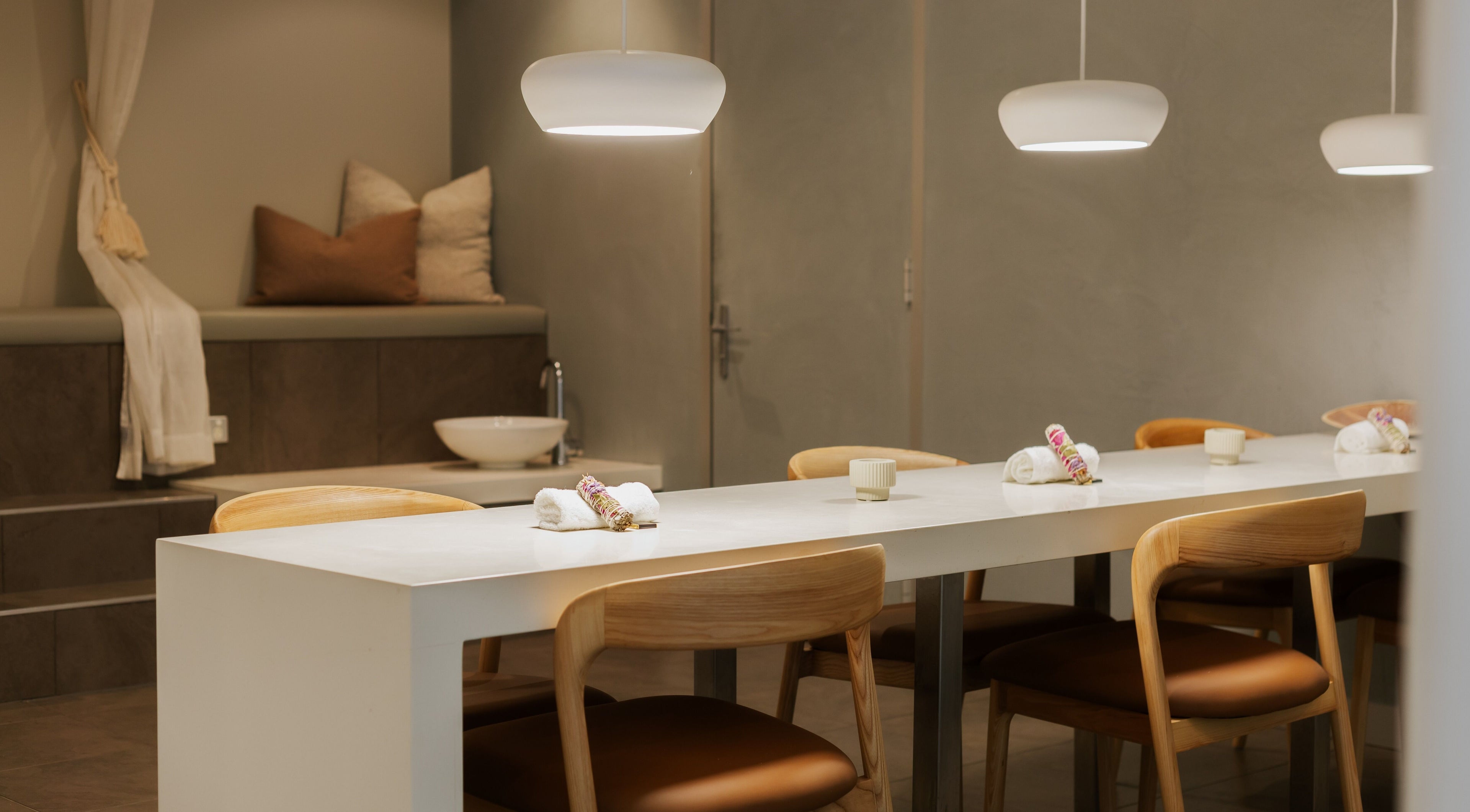 Relaxing treatment room at Solace Day Spa, Scarborough, Western Australia, AU with soft lighting and towels.