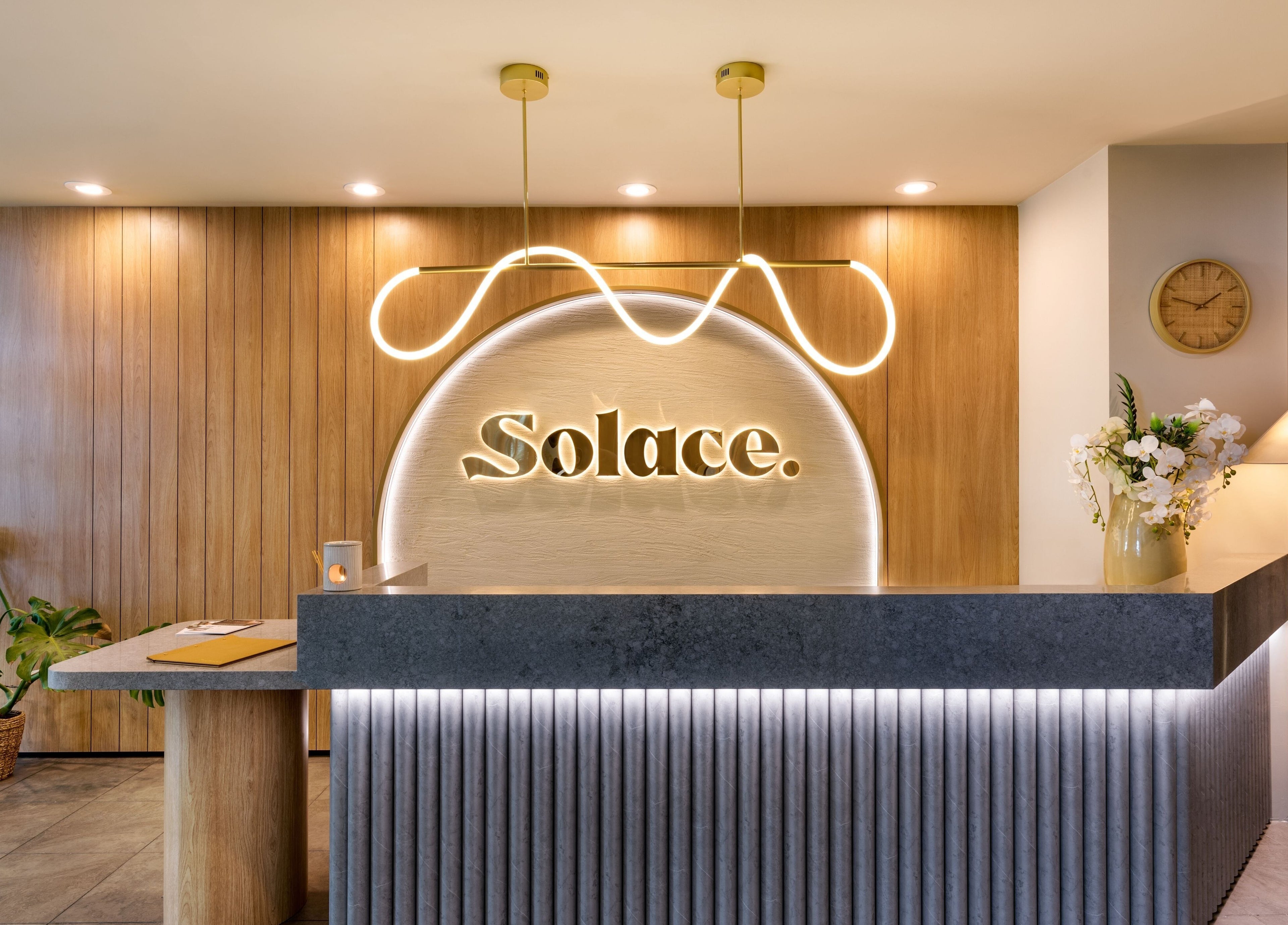 Warm, elegant reception at Solace Day Spa, Scarborough, Western Australia, AU with modern design and soft lighting.