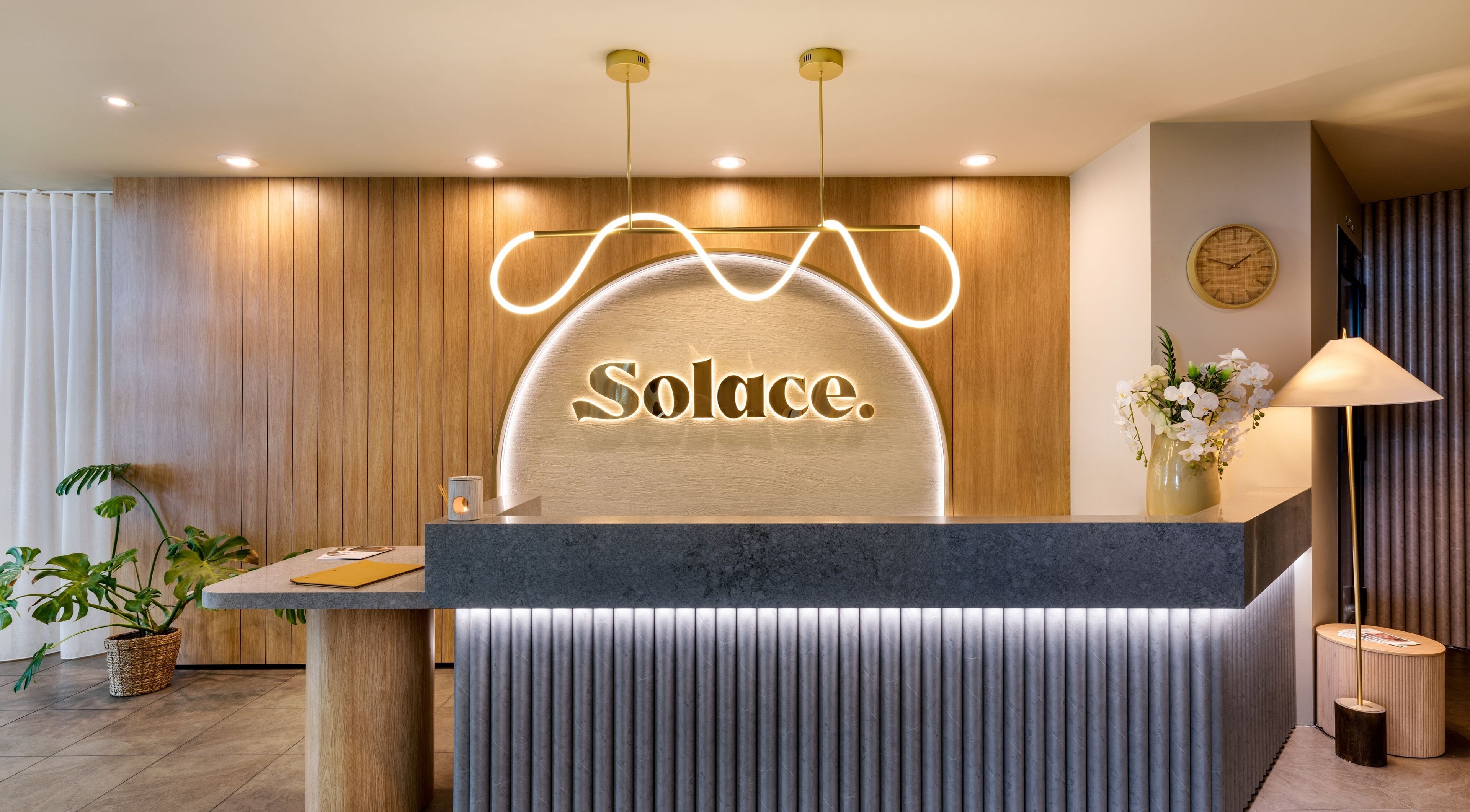 Warm, elegant reception at Solace Day Spa, Scarborough, Western Australia, AU with modern design and soft lighting.