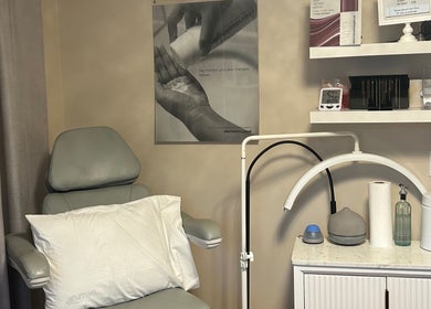 Cozy treatment room at Caring Esthetics, British Columbia, CA, with a comfy chair and skincare tools.