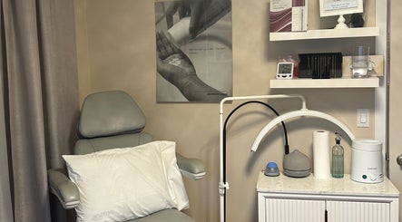 Cozy treatment room at Caring Esthetics, British Columbia, CA, with a comfy chair and skincare tools.