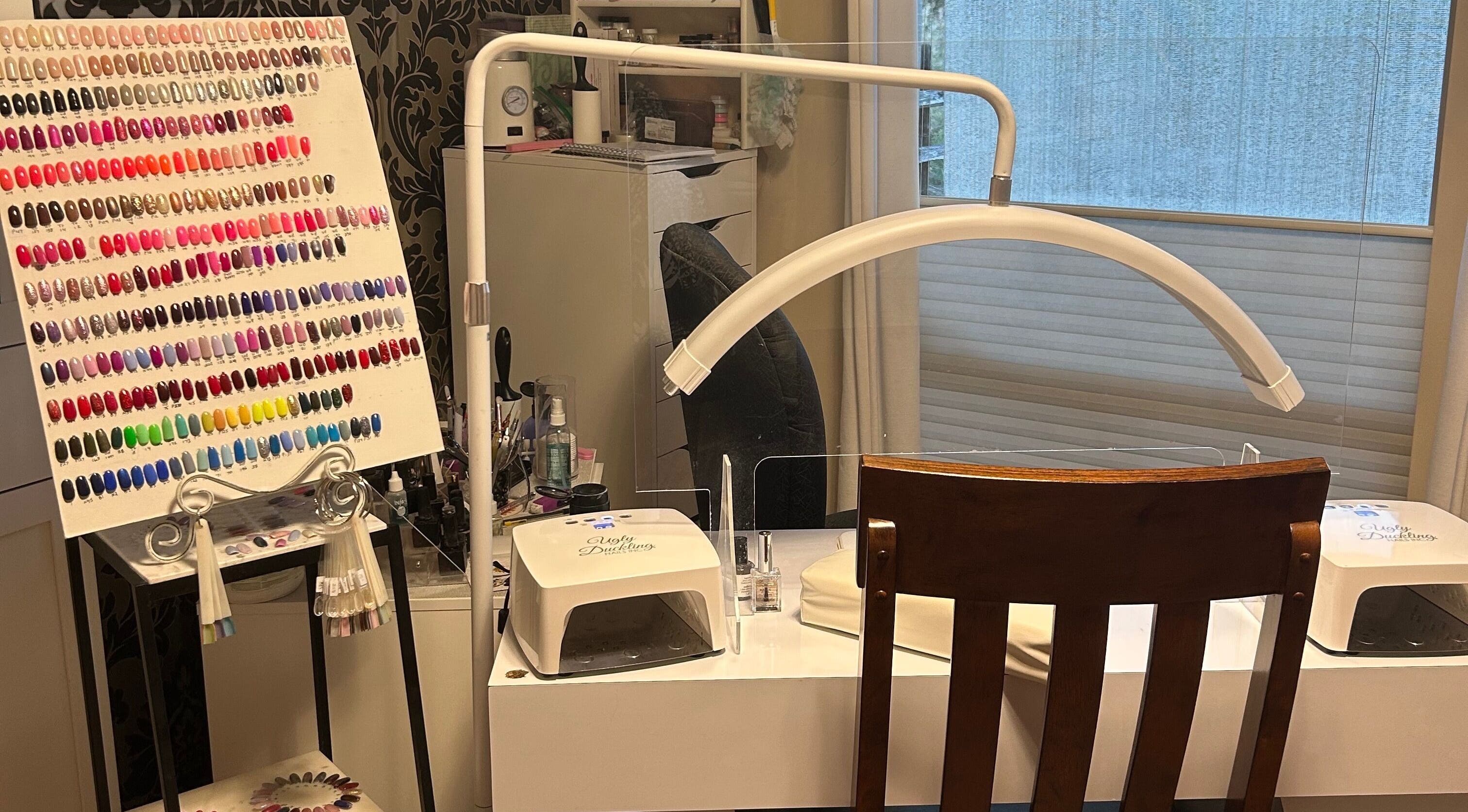 Nail station with vibrant polish display at Caring Esthetics by Mandy, British Columbia, British Columbia, CA.