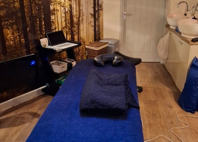 Tranquil massage room at Restore & Align Massage Therapy, Mansfield, England, GB with a cozy setup.