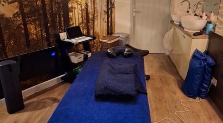 Tranquil massage room at Restore & Align Massage Therapy, Mansfield, England, GB with a cozy setup.