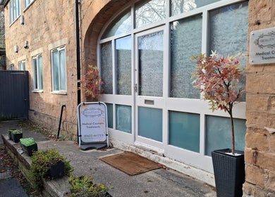 Entrance of Restore & Align Massage Therapy in Mansfield, England, GB showing elegant brickwork and greenery.