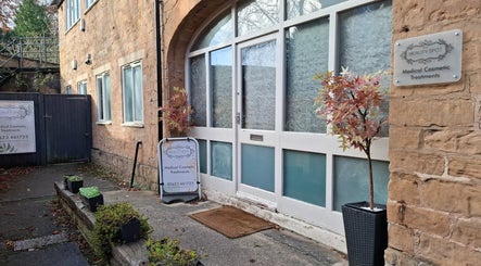 Entrance of Restore & Align Massage Therapy in Mansfield, England, GB showing elegant brickwork and greenery.