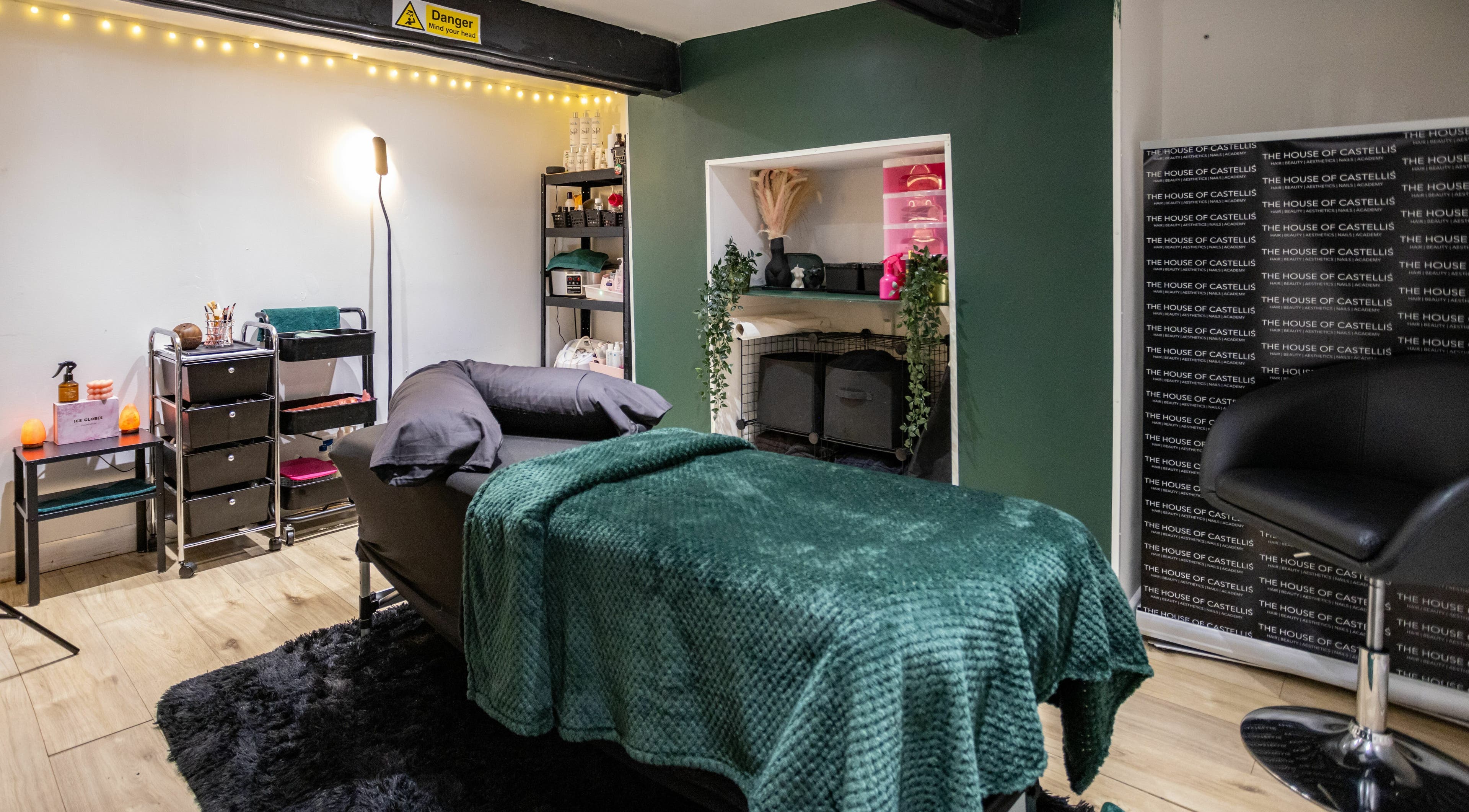 Luxurious spa room at The House of Castelliś, Hyde, England, GB with plush bed and modern decor.