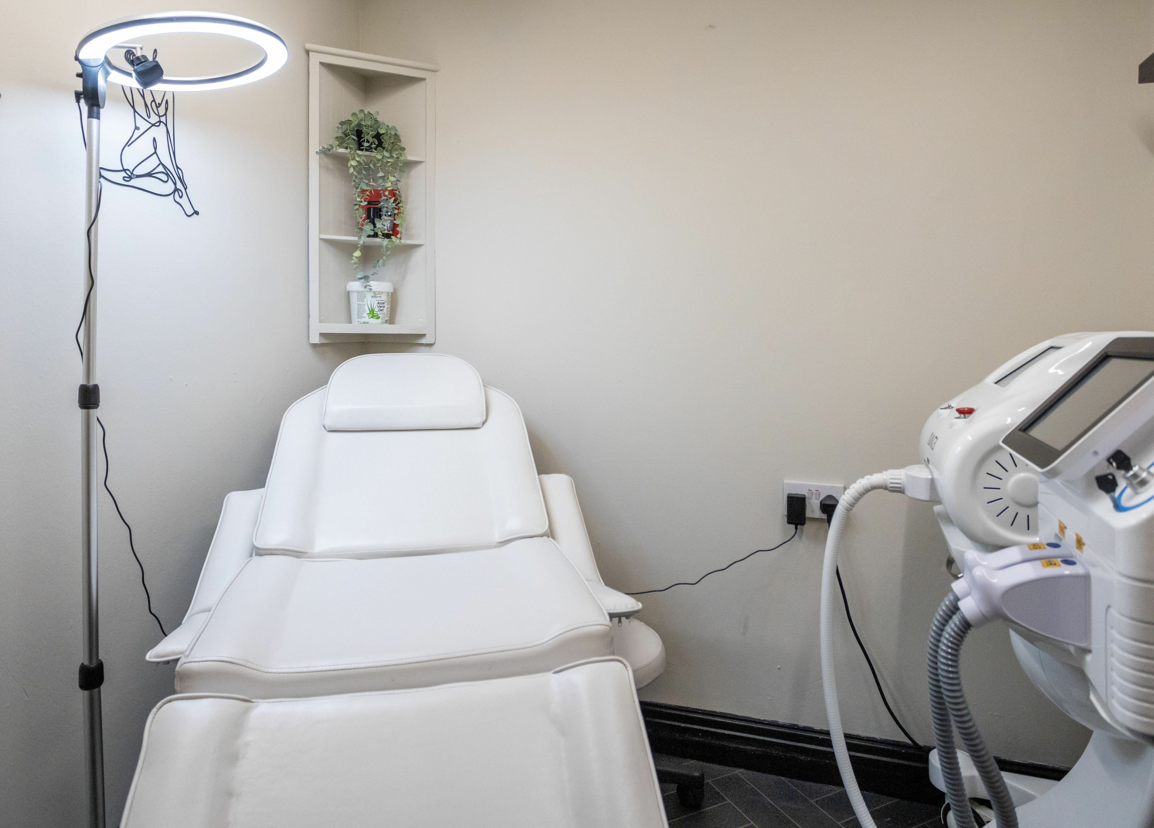 Calming treatment room at The House of Castelliś, Hyde, England, GB with sleek white aesthetics.