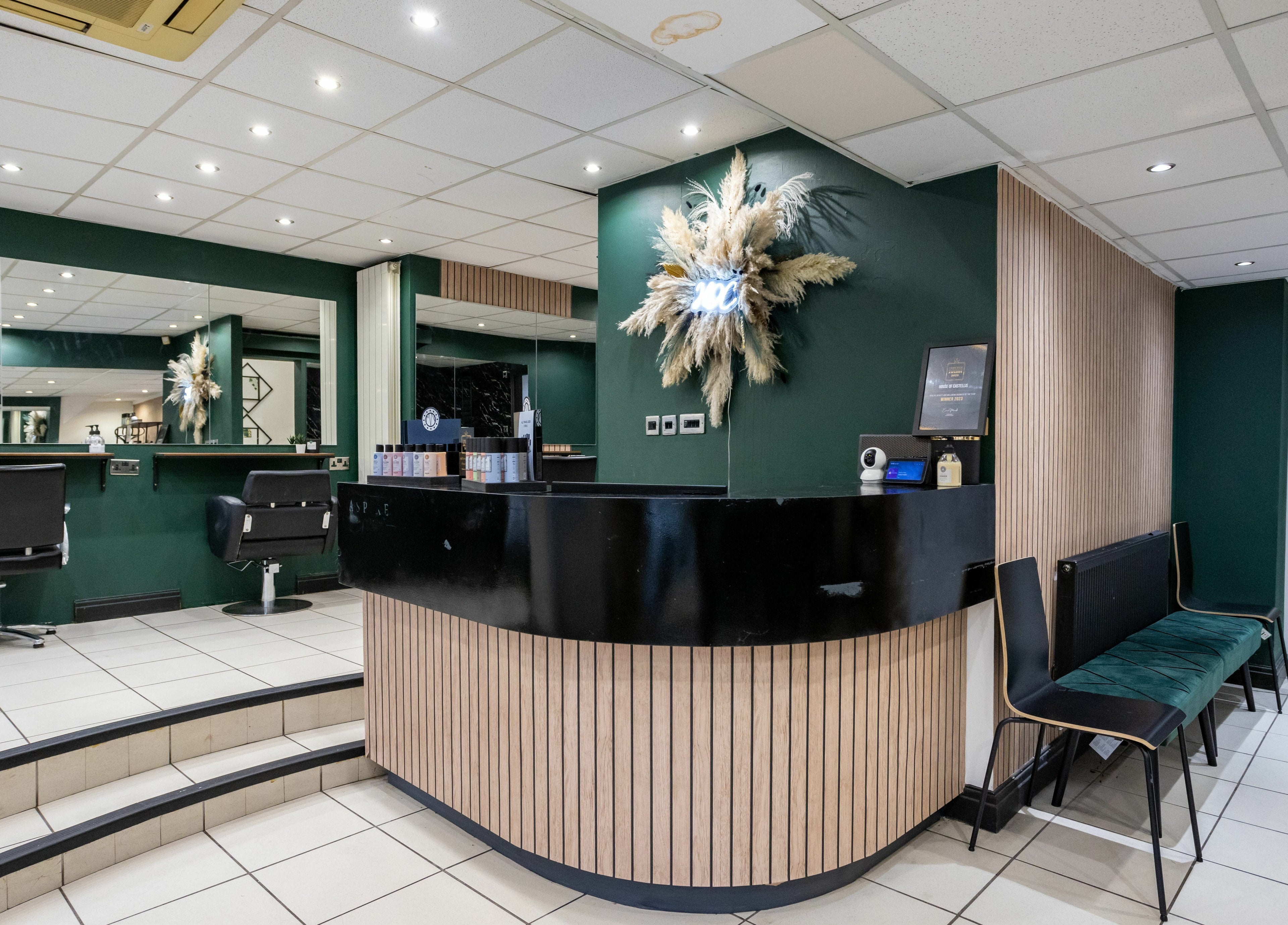 Chic salon interior at The House of Castelliś, Hyde, England, GB with modern styling chairs and decor.
