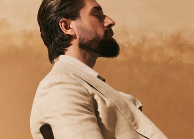Relaxed man at Kochi Dubai Gents Salon in Dubai, AE, showcasing a serene and sophisticated ambiance.