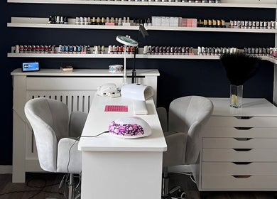 Elegant nail studio setup at Pampered Beauty, Elphinstone, Scotland, GB showcasing manicure station and polish displays.