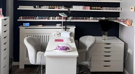 Elegant nail studio setup at Pampered Beauty, Elphinstone, Scotland, GB showcasing manicure station and polish displays.