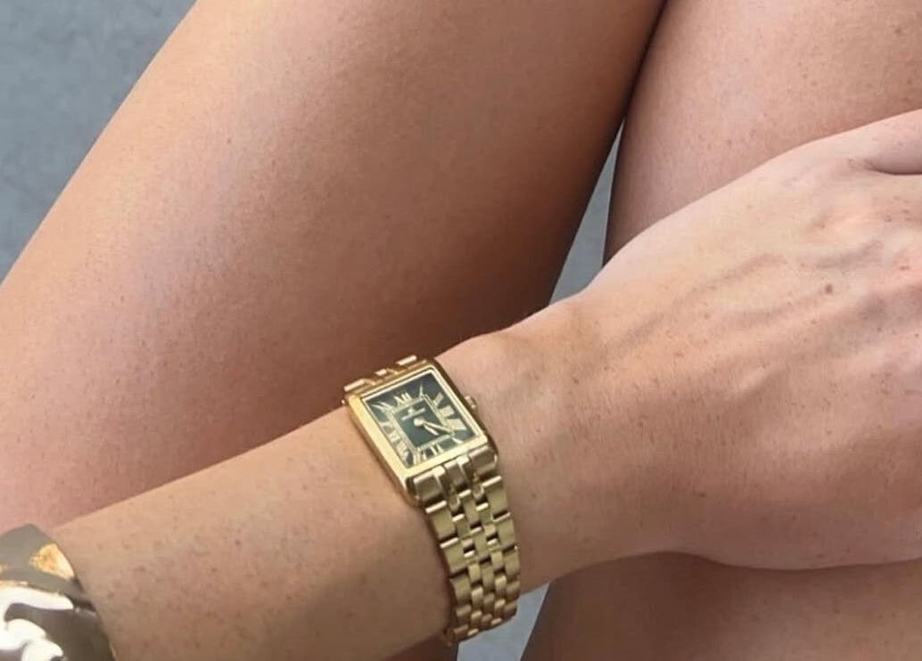 Close-up of tanned legs with a gold watch, highlighting Òir Spray Tanning's results in Perth and Kinross, Scotland, GB.