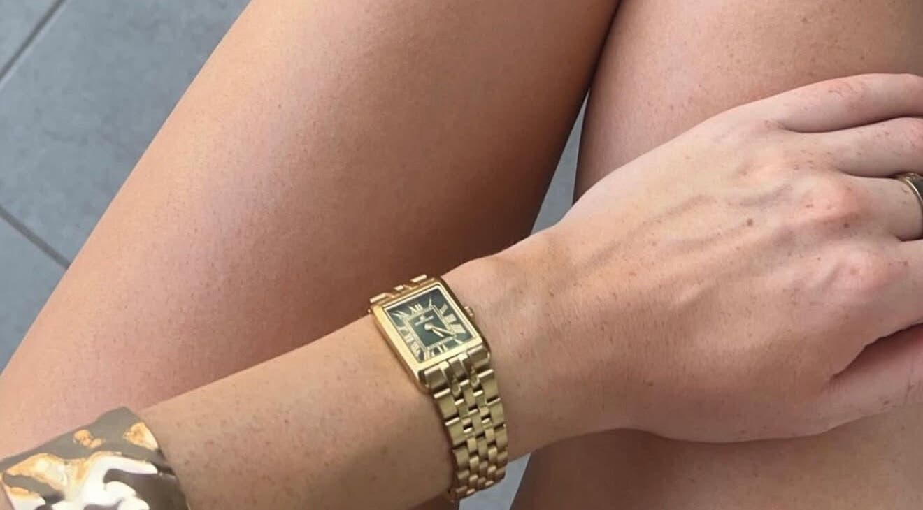 Close-up of tanned legs with a gold watch, highlighting Òir Spray Tanning's results in Perth and Kinross, Scotland, GB.