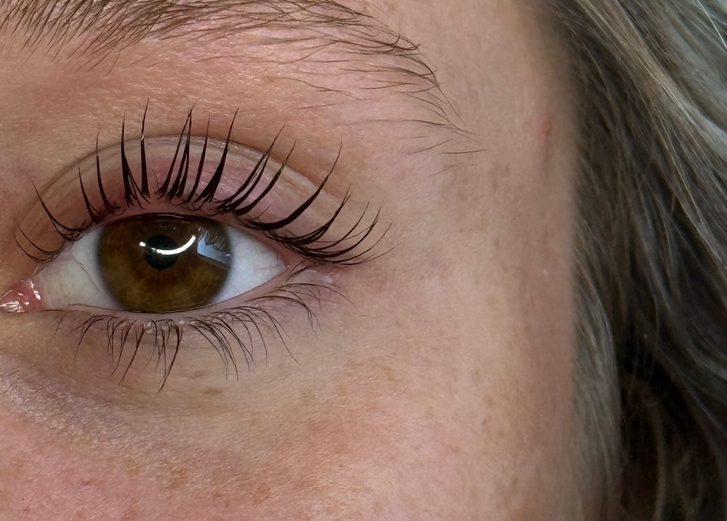 Close-up of eye with curled lashes at HB Beauty Hive, Dorridge, England, GB.